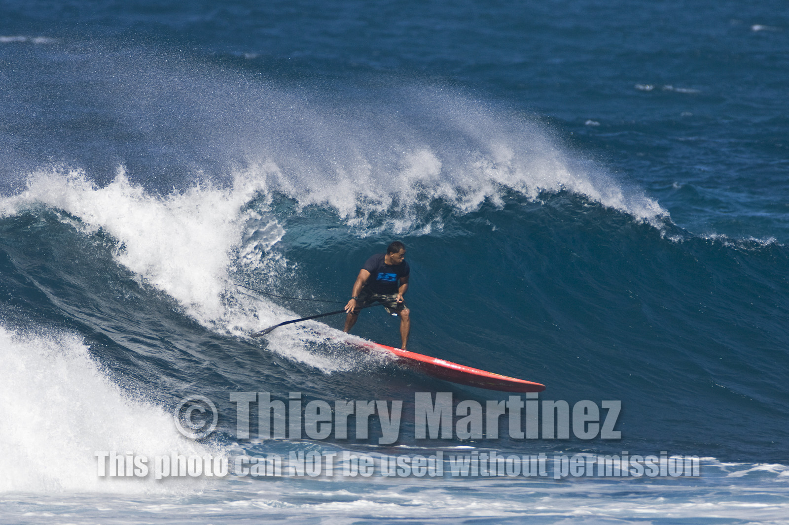 Stand Up Paddle  in waves at Hookip'a Beach - North Shore Maui - Hawaii.
