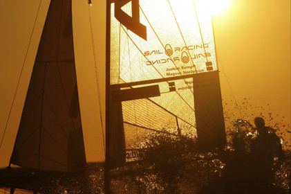 03_3243D  © Th.Martinez,STOCKHOLM ARCHIPELAGO SWEDEN, 10 07 03-Archipelago Raid (2003)  Day 3..Team NOKIA-Kempff  Magnus Nordstrom (SWE)& Joakim Kempff (SWE) sailing in sunset light on the way back from Finland to Sweden.
