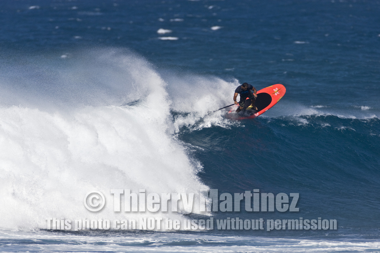 Stand Up Paddle  in waves at Hookip'a Beach - North Shore Maui - Hawaii.