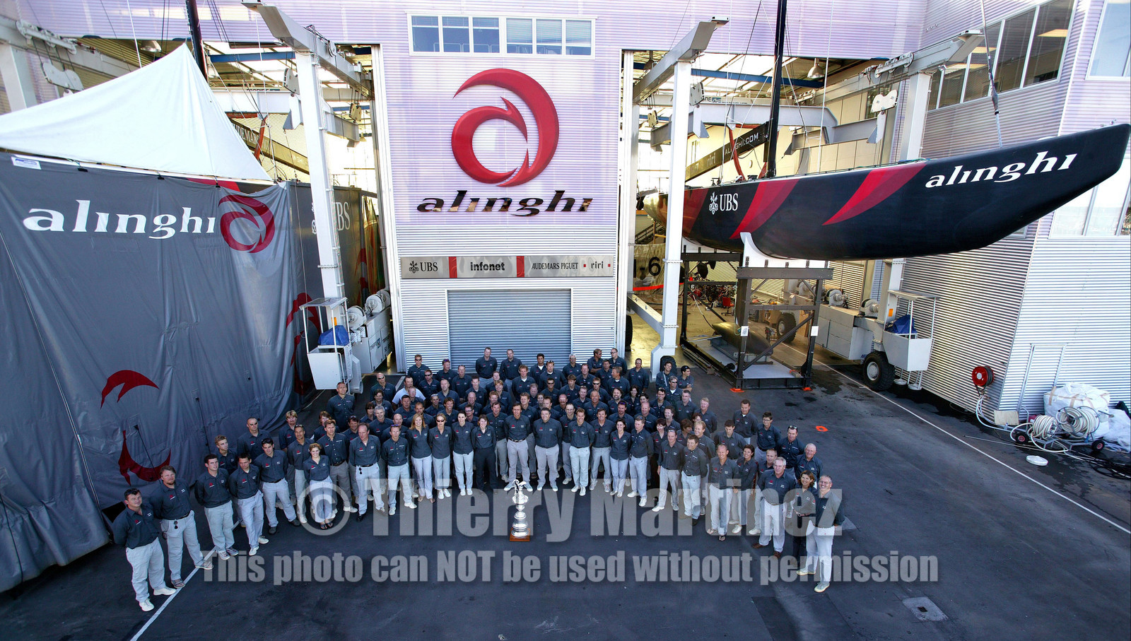 03_1511D ©Th.Martinez . Auckland New Zealand. 3rd March 2003. Alinghi Team winner of the 31 America's Cup around the Cup in front of the boat shed at Alinghi Base.