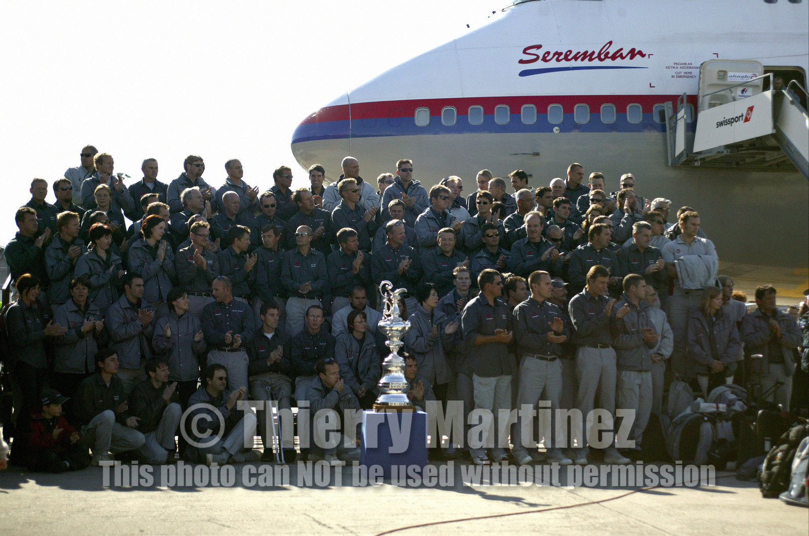 03_2213D ©Th.Martinez Team .Geneva , Switzerland. America's Cup 2003. 8th March 2003.Alinghi Team winner of America's Cup 2003, arriving in Geneva Airport with thE America's Cup..All Alinghi Team behing the America's Cup at Genava airport ....